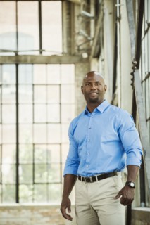 Black businessman smiling in warehouse