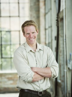 Caucasian businessman smiling in warehouse