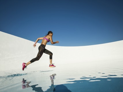 Mixed race woman running on water surface