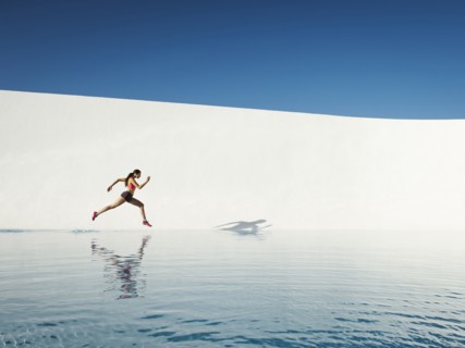 Caucasian woman running on water surface