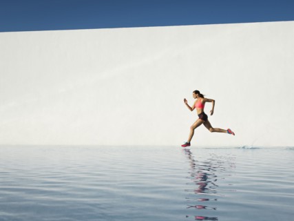 Caucasian woman running on water surface