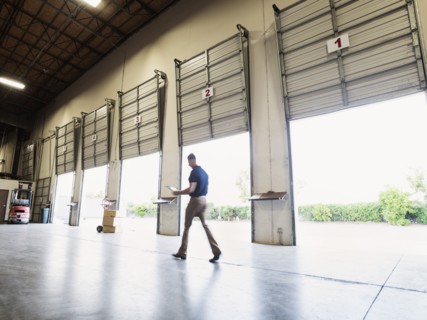 Blurred view of Caucasian worker walking in warehouse