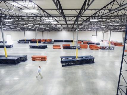 High angle view of Caucasian businessman walking in empty warehouse