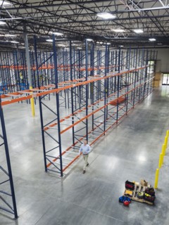 High angle view of Caucasian businessman walking in empty warehouse