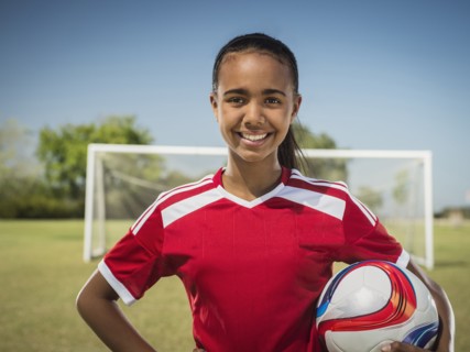 Mixed race soccer player standing on field