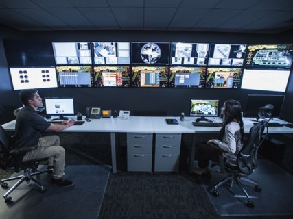 Security guards watching monitors in control room