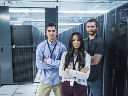Technicians smiling in server room