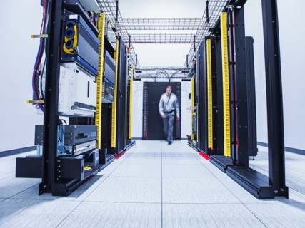 Blurred view of Hispanic technician walking in server room