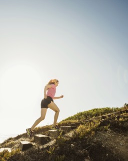 Caucasian woman jogging uphill