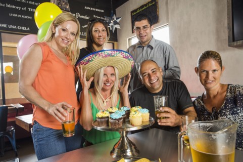 Friends celebrating birthday in cafe