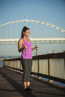 Caucasian woman working out on urban bridge