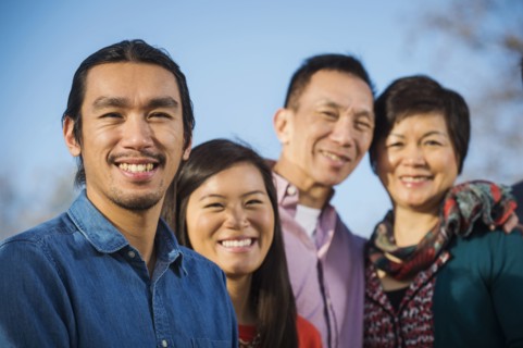 Chinese family smiling outdoors