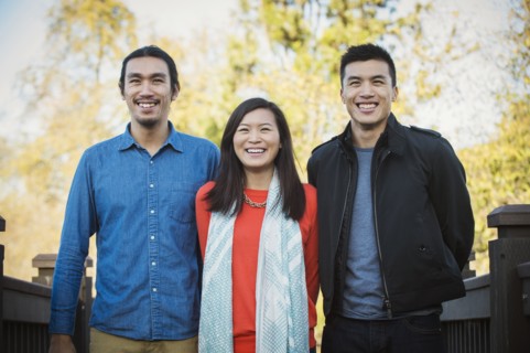 Adult Chinese siblings smiling outdoors