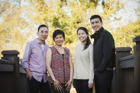 Chinese family smiling outdoors