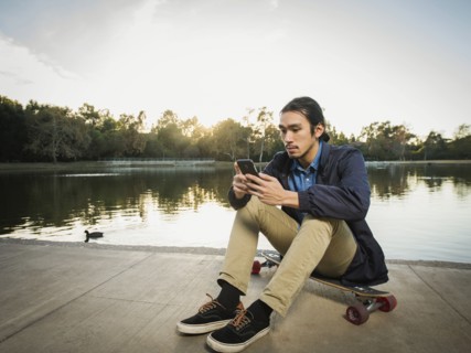 Chinese man using cell phone in park