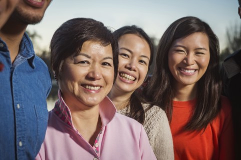Chinese family smiling outdoors