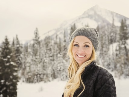 Caucasian woman smiling in snow