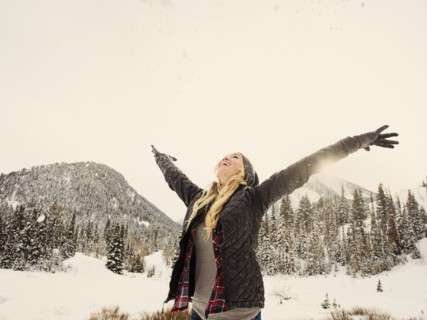 Caucasian woman playing in snow