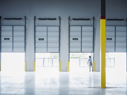Caucasian businessman lifting loading dock door