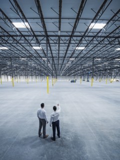 Businessmen talking in empty warehouse