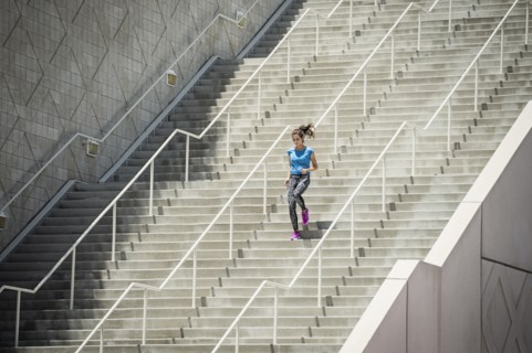 Caucasian woman running on staircase