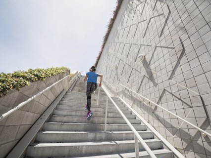 Caucasian woman running on staircase