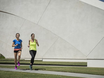Caucasian women running near architecture