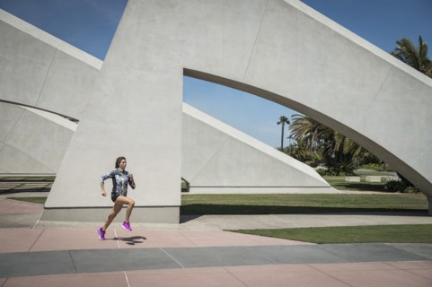 Caucasian woman running near architecture