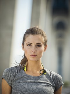 Serious Caucasian woman posing under overpass