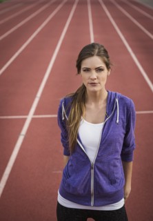 Caucasian woman posing on running track