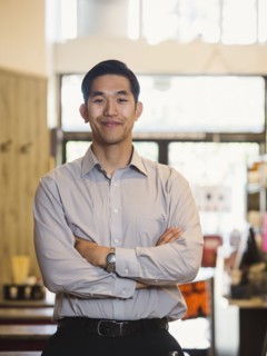 Smiling Chinese man posing in restaurant