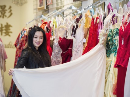 Smiling Chinese woman shopping for dress