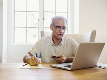 Caucasian man online shopping on laptop