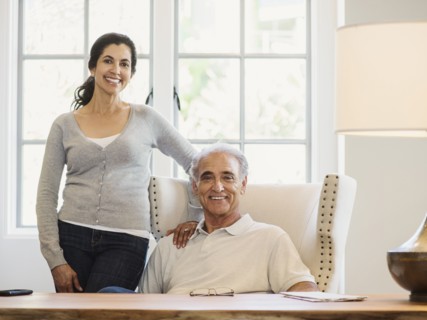 Portrait of couple posing near window