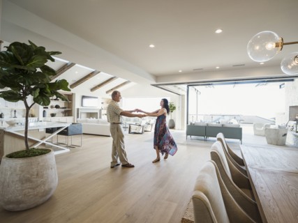 Older couple dancing in modern home