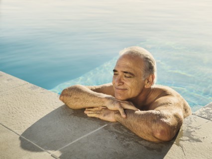 Portrait of Caucasian man relaxing in swimming pool