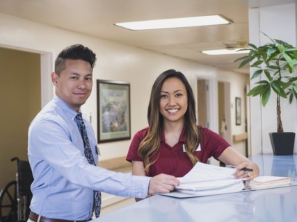 Smiling doctor and nurse in hospital