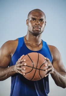 Confident black man holding basketball