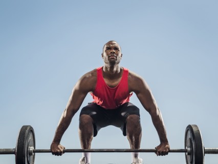 Black man preparing for lifting barbell