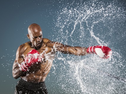 Water splashing on black boxer punching