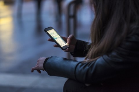 Caucasian woman texting on cell phone outdoors