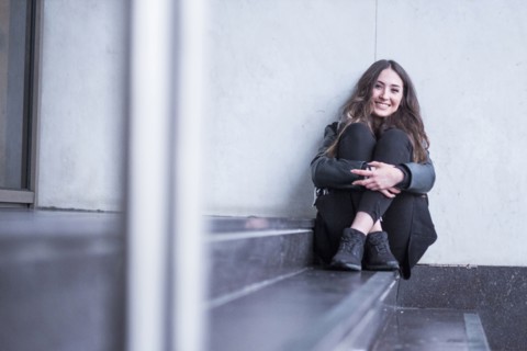 Smiling Caucasian woman sitting on staircase