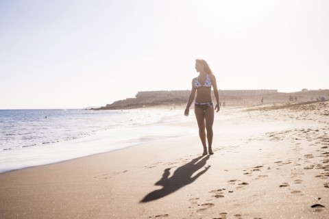 Caucasian woman walking on beach