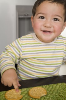 Hispanic baby boy eating crackers