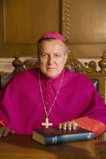 Hispanic bishop sitting with bible