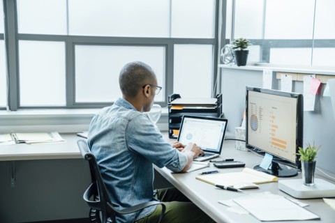 Black businessman using laptop in office