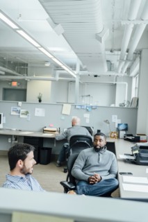 Businessmen talking in office
