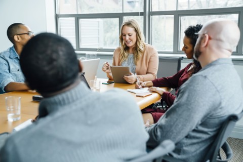 Businesswoman reading digital tablet in meeting