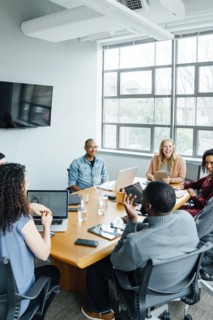 Business people smiling in meeting