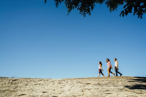 Friends walking under blue sky